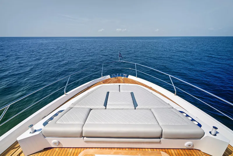 Slide: The Image of Fairline 2024 Squadron 68 yacht bow with sun loungers, overlooking the ocean. - 12