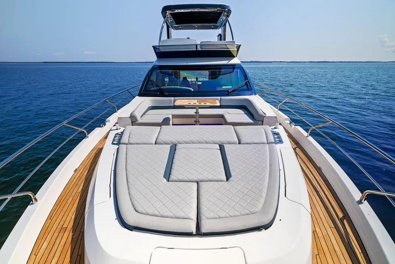 Slide: The Image of Luxury Fairline 2024 Squadron 68 yacht with spacious sun deck on open water. - 9