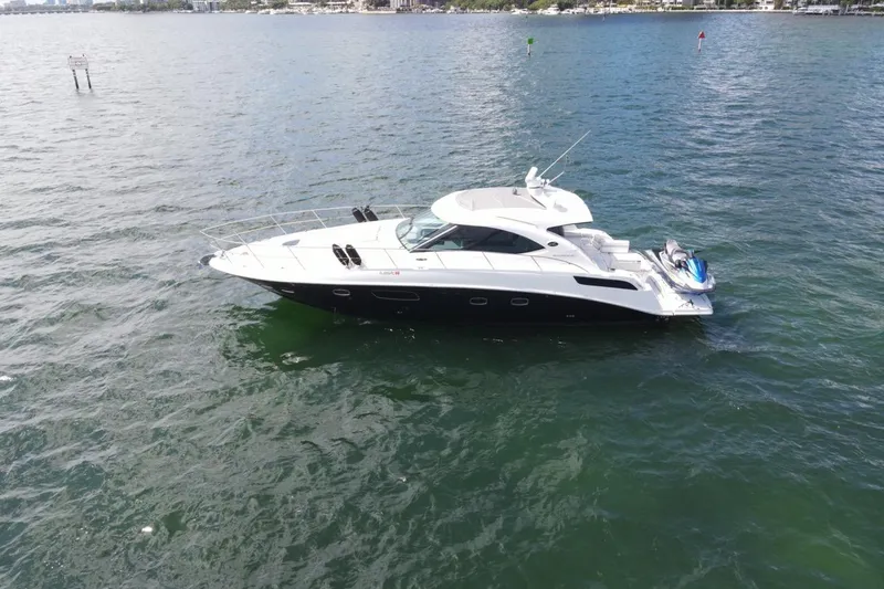 Slide: The Image of 2011 Sea Ray 470 Sundancer yacht on open water, side view. - 12