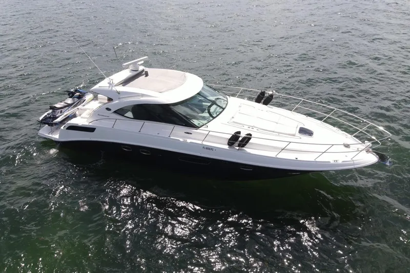 Slide: The Image of 2011 Sea Ray 470 Sundancer yacht cruising on open water. - 14