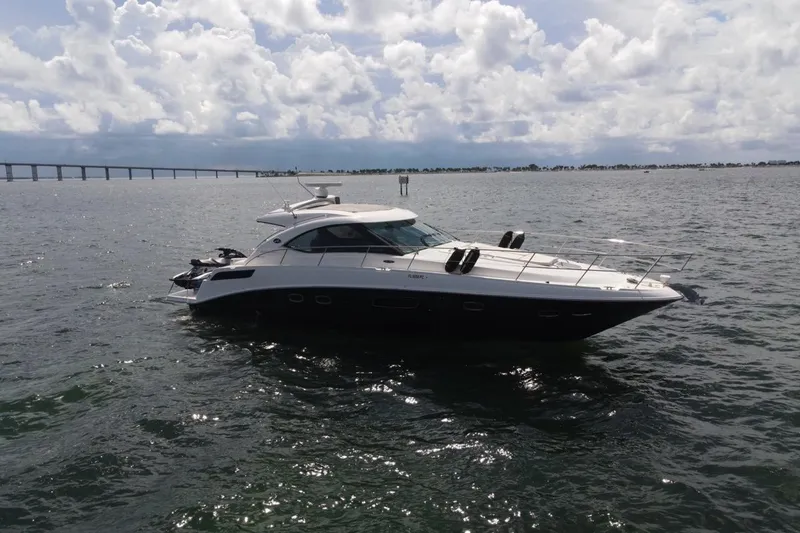 Slide: The Image of 2011 Sea Ray 470 Sundancer yacht on open water under cloudy sky. - 15