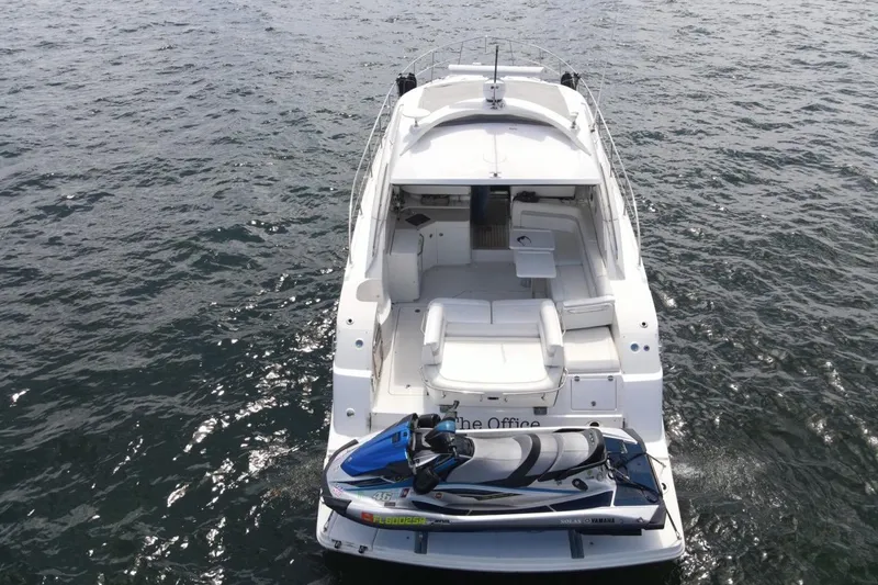 Slide: The Image of 2011 Sea Ray 470 Sundancer yacht with jet ski on open water. - 17