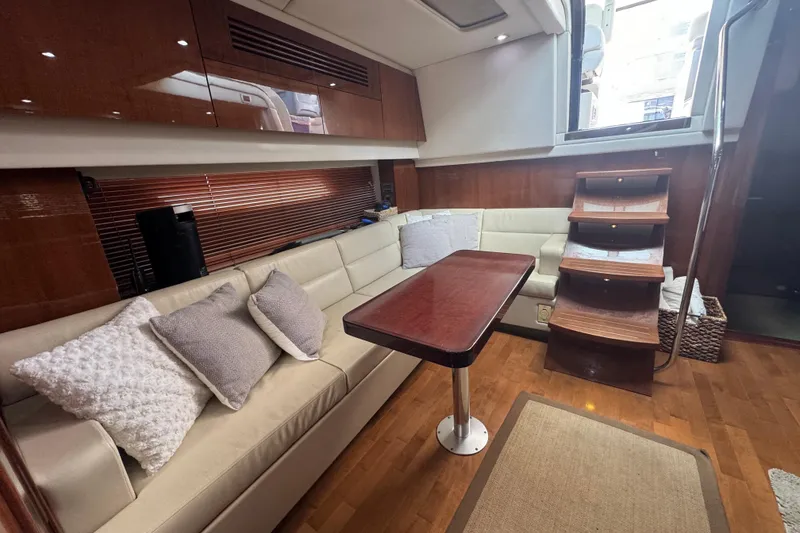 Slide: The Image of Luxurious interior of 2011 Sea Ray 470 Sundancer yacht with plush seating and wooden accents. - 23