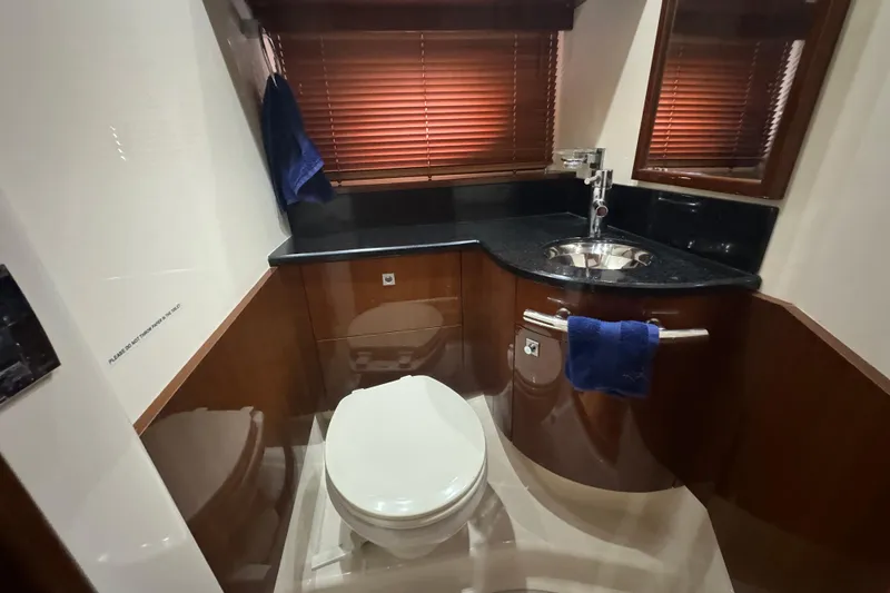 Slide: The Image of Luxurious bathroom in 2011 Sea Ray 470 Sundancer yacht with modern fixtures and wooden accents. - 25