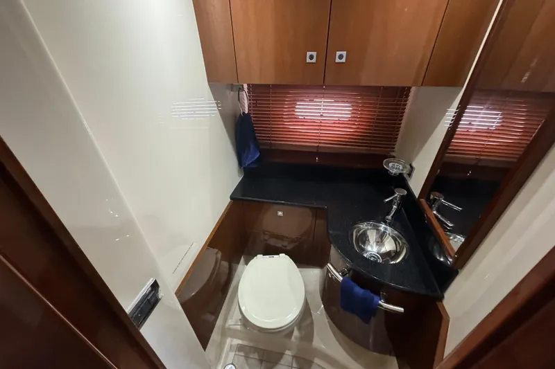 Slide: The Image of Luxurious bathroom in 2011 Sea Ray 470 Sundancer yacht with modern fixtures and wood accents. - 26