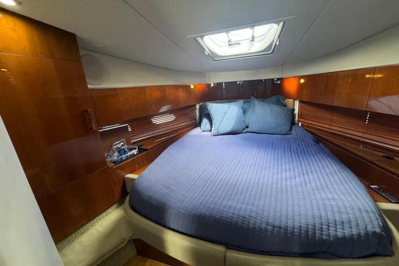 Slide: The Image of Luxurious cabin interior of 2011 Sea Ray 470 Sundancer yacht with blue bedding. - 27
