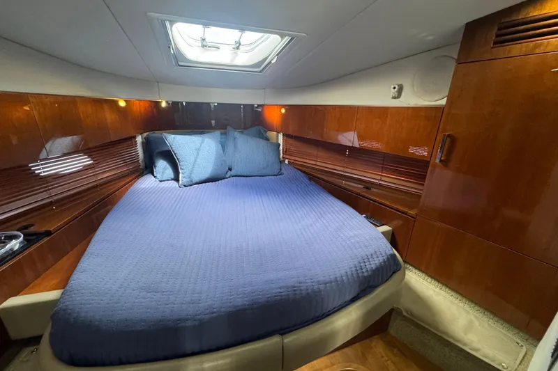 Slide: The Image of Luxurious cabin interior of 2011 Sea Ray 470 Sundancer yacht with blue bedding. - 28