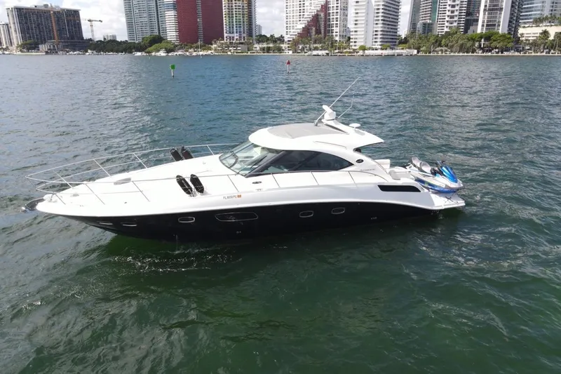 Slide: The Image of 2011 Sea Ray 470 Sundancer yacht on water with city skyline background. - 3