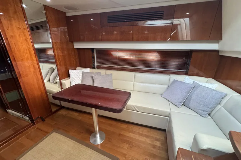 Slide: The Image of Luxurious interior of 2011 Sea Ray 470 Sundancer yacht with plush seating and wooden accents. - 32