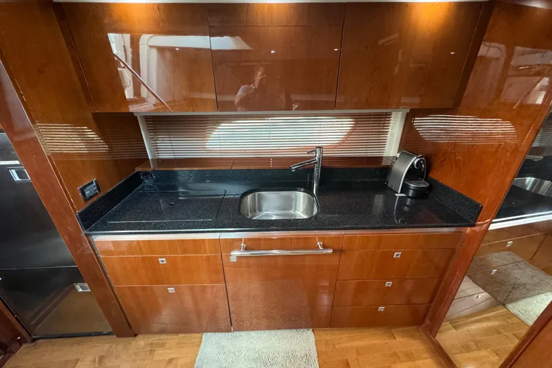 Slide: The Image of Luxurious kitchen area in a 2011 Sea Ray 470 Sundancer yacht with sleek cabinetry. - 36