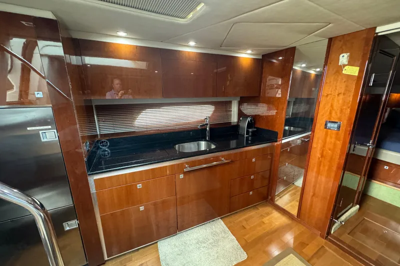 Slide: The Image of Luxurious kitchen interior of 2011 Sea Ray 470 Sundancer yacht with wood cabinetry. - 37