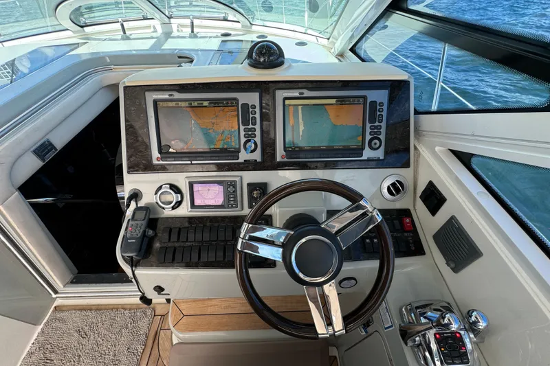 Slide: The Image of Control panel of a 2011 Sea Ray 470 Sundancer yacht with navigation screens. - 38