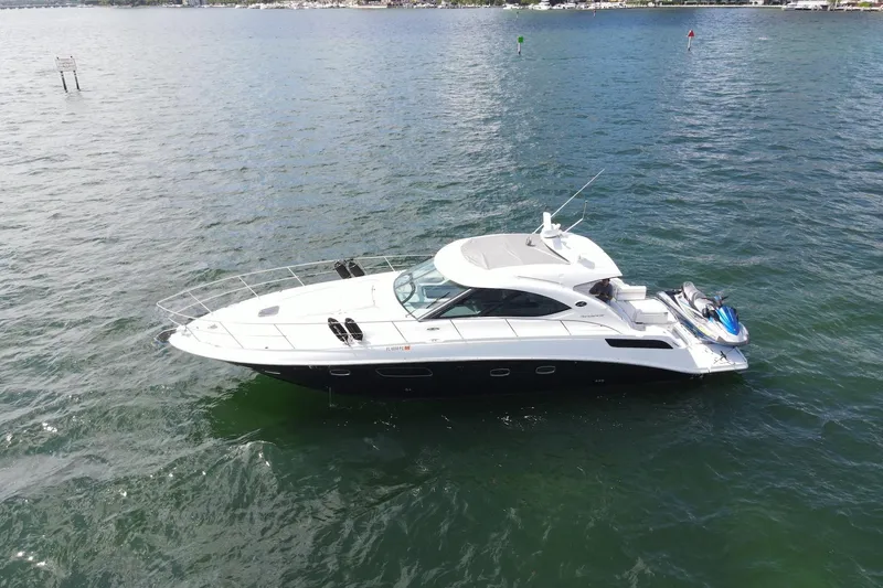 Slide: The Image of 2011 Sea Ray 470 Sundancer yacht cruising on open water. - 4