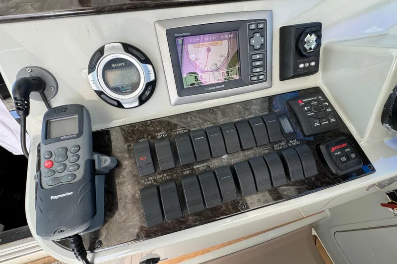 Slide: The Image of Control panel of a 2011 Sea Ray 470 Sundancer with navigation and communication equipment. - 41