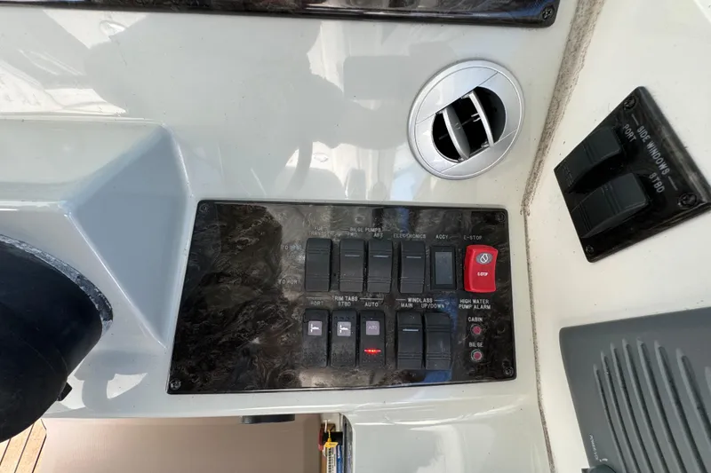 Slide: The Image of Control panel of a 2011 Sea Ray 470 Sundancer boat with switches and dials. - 42