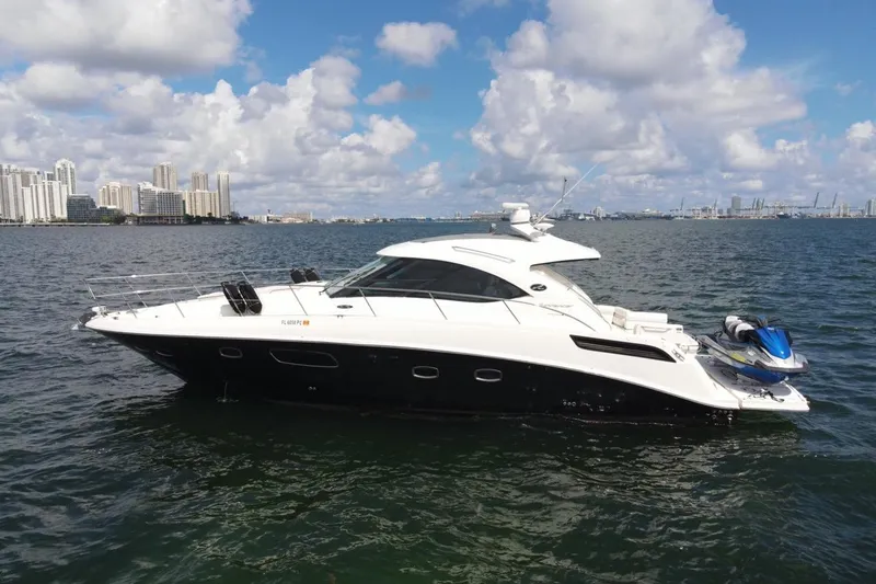 Slide: The Image of 2011 Sea Ray 470 Sundancer yacht on water with city skyline background. - 5