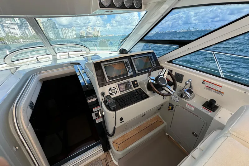 Slide: The Image of Interior helm of 2011 Sea Ray 470 Sundancer yacht with navigation controls and ocean view. - 51