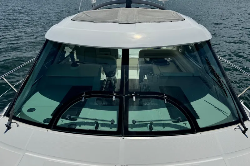 Slide: The Image of 2011 Sea Ray 470 Sundancer yacht on water, showcasing sleek design and spacious interior. - 64