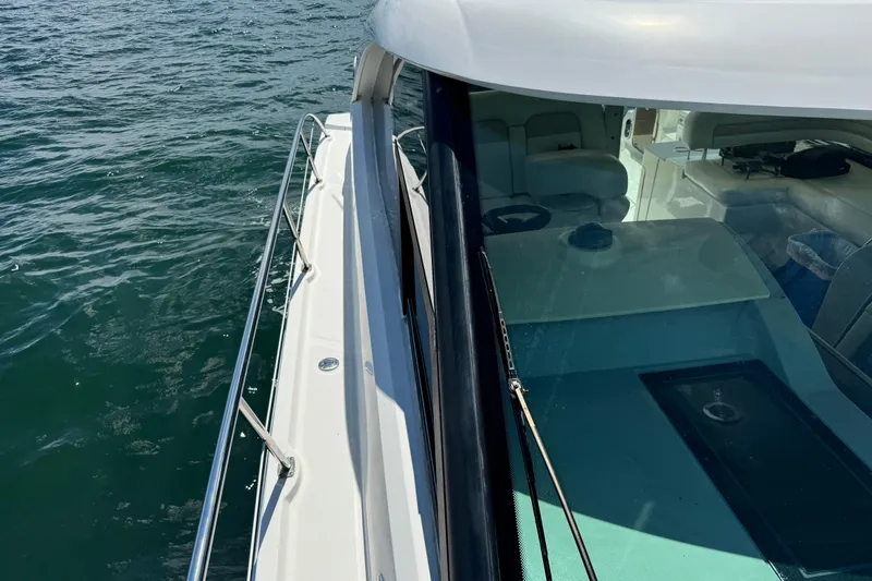 Slide: The Image of 2011 Sea Ray 470 Sundancer yacht on water, showcasing sleek design and spacious interior. - 66