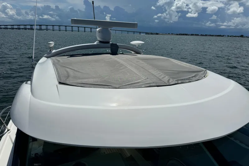 Slide: The Image of 2011 Sea Ray 470 Sundancer yacht on water, bridge in background, cloudy sky. - 67