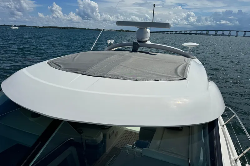 Slide: The Image of 2011 Sea Ray 470 Sundancer yacht on water, bridge in background, sunny day. - 68