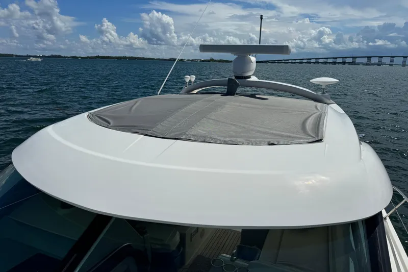Slide: The Image of 2011 Sea Ray 470 Sundancer yacht on open water, showcasing sleek design and radar equipment. - 69