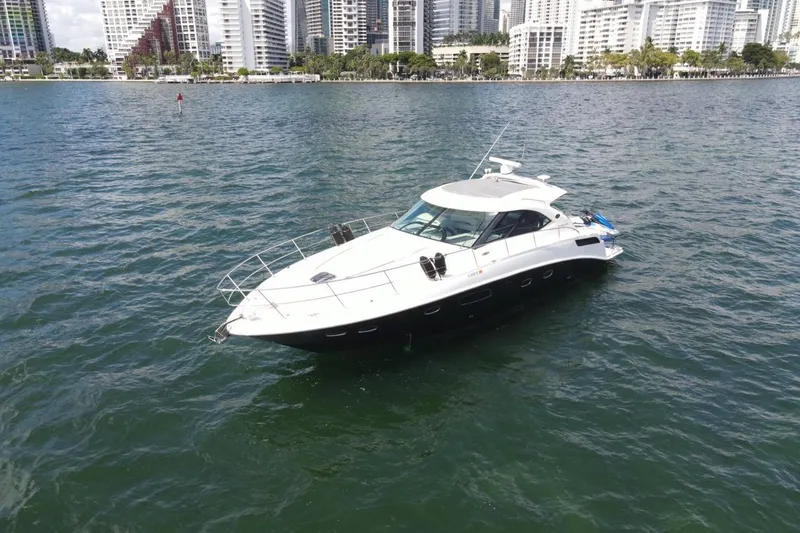 Slide: The Image of 2011 Sea Ray 470 Sundancer yacht on water with city skyline backdrop. - 7