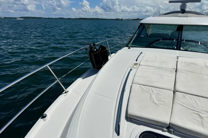 Slide: The Image of 2011 Sea Ray 470 Sundancer yacht on open water, featuring spacious deck and seating. - 72