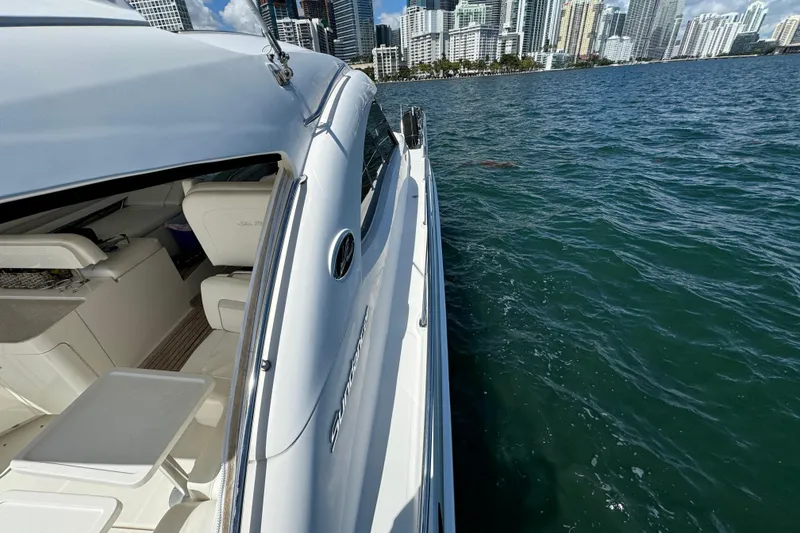 Slide: The Image of 2011 Sea Ray 470 Sundancer yacht cruising near city skyline. - 75