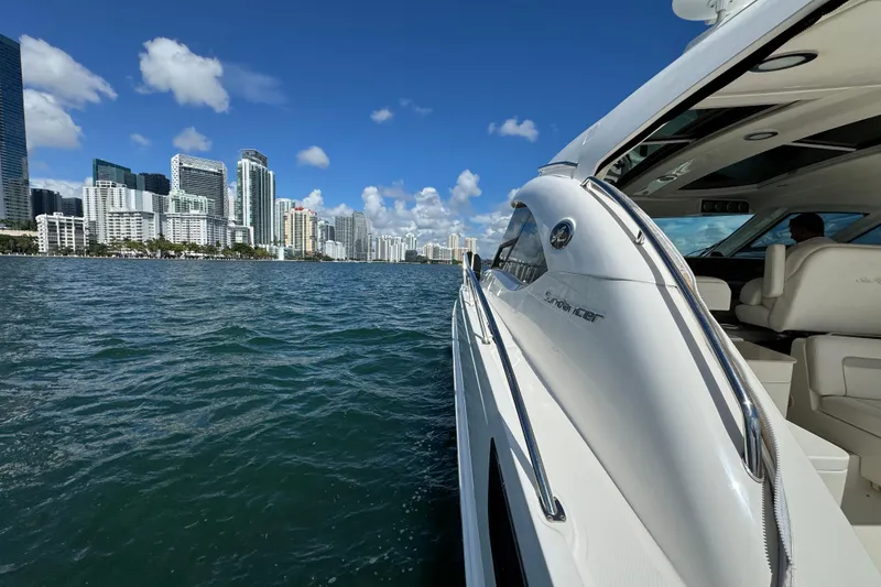 Slide: The Image of Sea Ray 470 Sundancer yacht cruising near city skyline, 2011 model. - 76