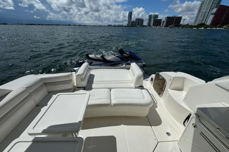 Slide: The Image of Luxurious 2011 Sea Ray 470 Sundancer yacht with spacious deck and scenic waterfront view. - 78