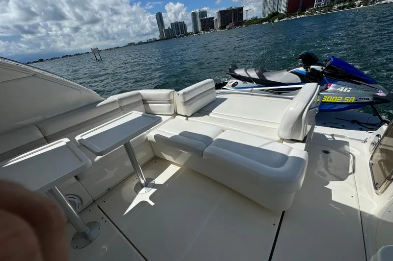 Slide: The Image of Luxurious 2011 Sea Ray 470 Sundancer yacht with white seating and jet ski on deck. - 79