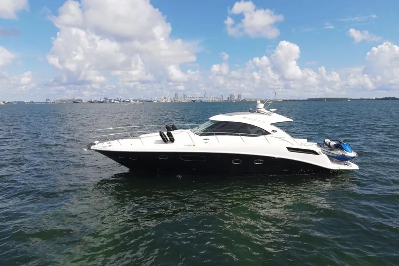 Slide: The Image of 2011 Sea Ray 470 Sundancer yacht on open water under a blue sky. - 8