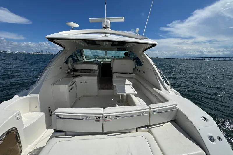 Slide: The Image of 2011 Sea Ray 470 Sundancer yacht interior with seating, table, and ocean view. - 82