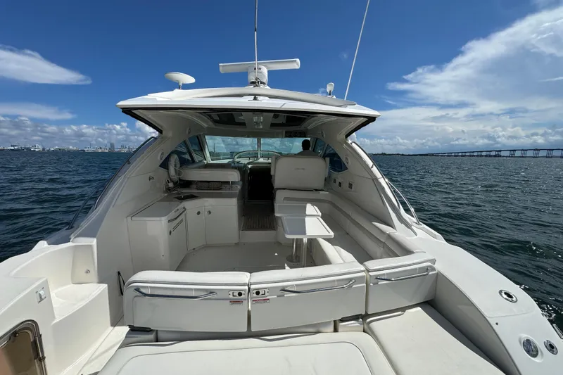 Slide: The Image of 2011 Sea Ray 470 Sundancer yacht interior with seating, table, and ocean view. - 83
