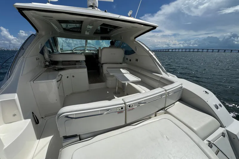 Slide: The Image of 2011 Sea Ray 470 Sundancer yacht interior with ocean view and bridge in background. - 84