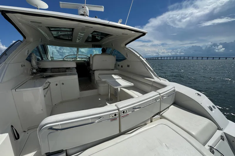 Slide: The Image of 2011 Sea Ray 470 Sundancer yacht interior with ocean view and bridge in background. - 85