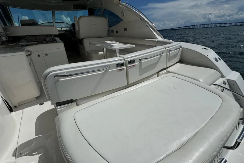 Slide: The Image of Luxurious 2011 Sea Ray 470 Sundancer yacht interior with white seating and ocean view. - 88