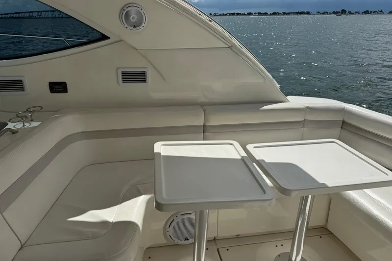 Slide: The Image of Luxurious 2011 Sea Ray 470 Sundancer yacht interior with seating and tables, overlooking the ocean. - 89