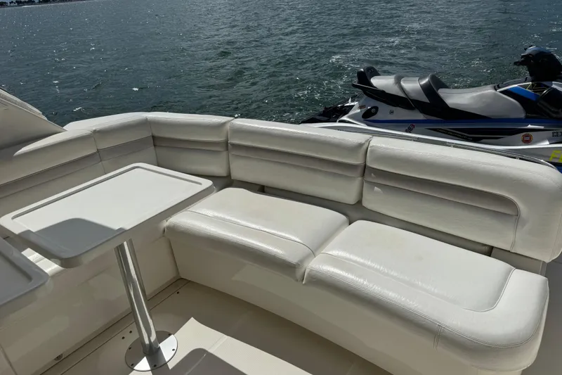 Slide: The Image of Luxurious seating area on 2011 Sea Ray 470 Sundancer yacht with watercraft nearby. - 90