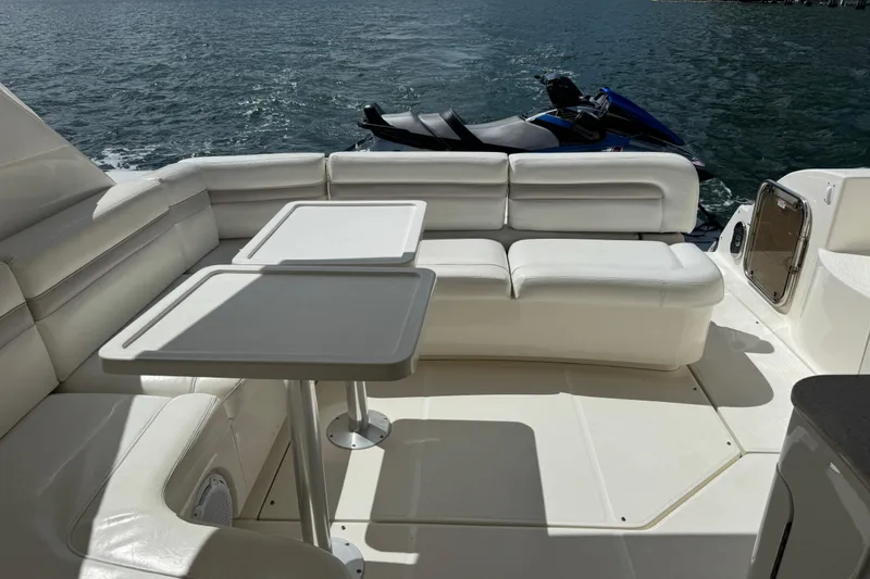 Slide: The Image of 2011 Sea Ray 470 Sundancer yacht interior with white seating and table, ocean view. - 94