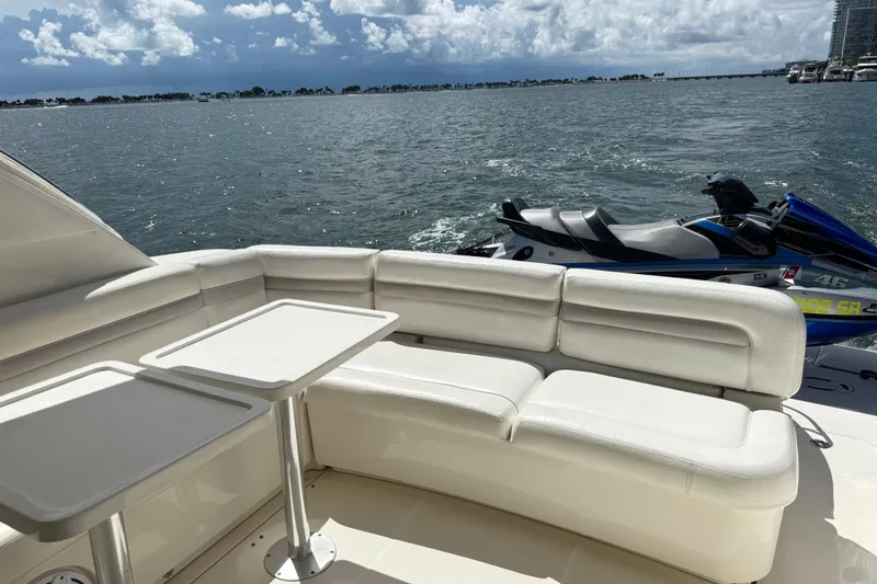 Slide: The Image of Luxury seating on 2011 Sea Ray 470 Sundancer yacht with jet ski and ocean view. - 95