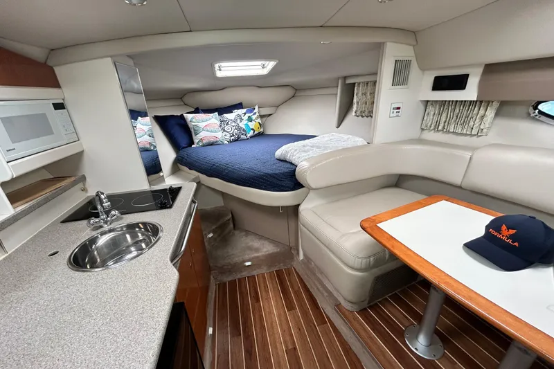 Slide: The Image of Interior of 2000 Formula 31 Performance Cruiser with kitchenette, seating, and cozy sleeping area. - 18