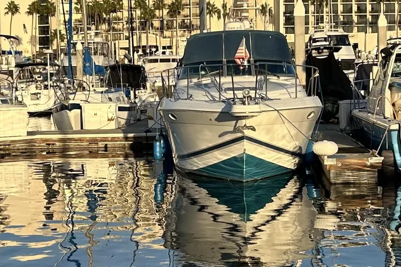 Slide: The Image of 2000 Formula 31 Performance Cruiser docked in a marina, reflecting on calm water. - 2