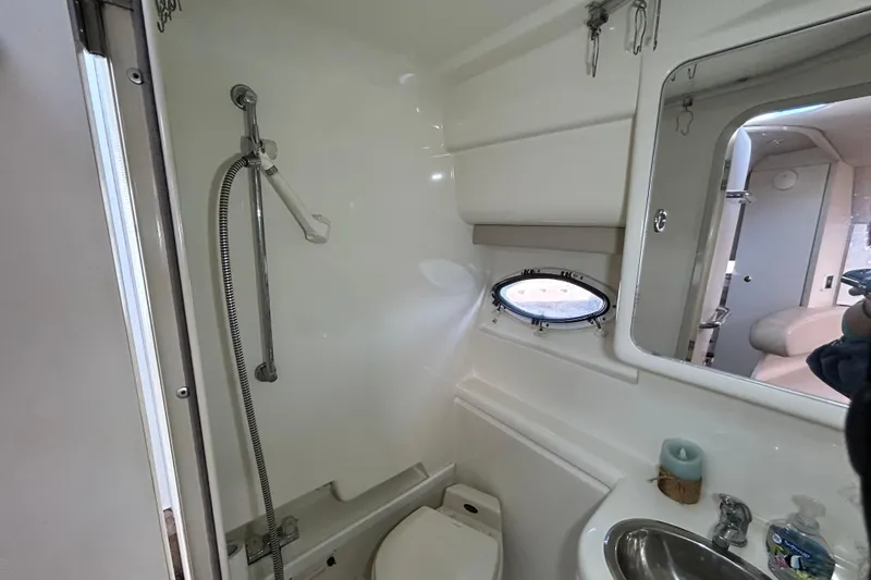 Slide: The Image of "Wet" head with shower, sink, and porthole window. - 25