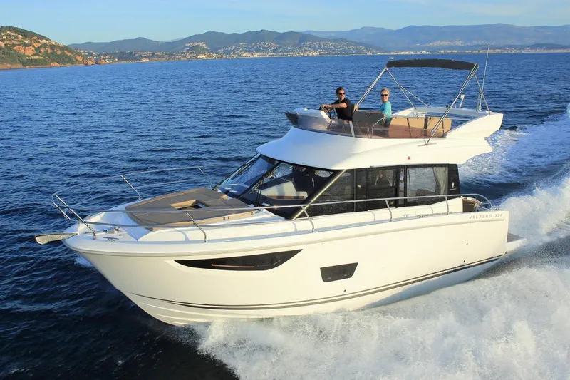 The Image of Manufacturer Provided Image: 2018 Jeanneau Velasco 37F cruising on open water with scenic mountain backdrop. - 0