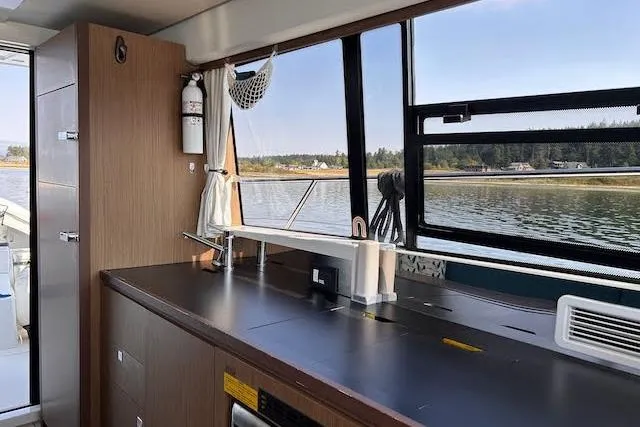 Slide: The Image of Interior of 2018 Jeanneau Velasco 37F yacht with sleek kitchen and scenic water view. - 16