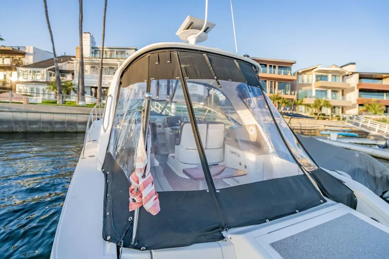 Slide: The Image of 2016 Sea Ray 370 Express Cruiser docked near waterfront homes. - 11