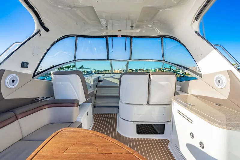 Slide: The Image of Interior view of 2016 Sea Ray 370 Express Cruiser with seating and helm. - 16