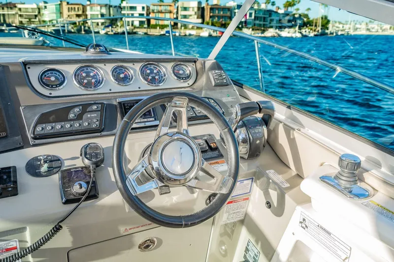 Slide: The Image of Cockpit of 2016 Sea Ray 370 Express Cruiser with steering wheel and controls. - 22
